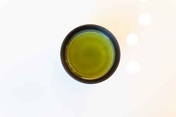Cup of green tea on white background