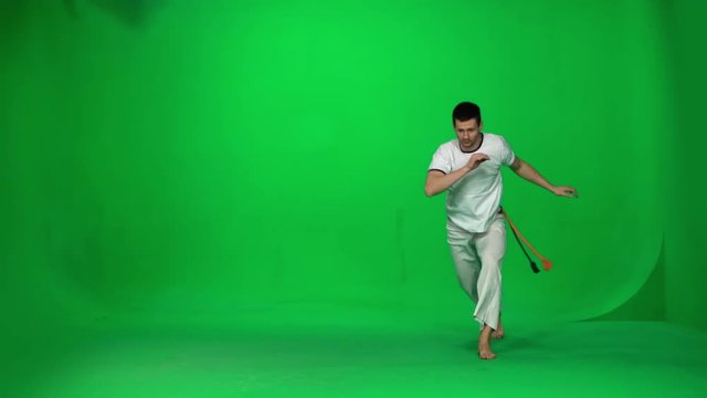 Man practicing capoeira on chroma key studio. Slow motion.