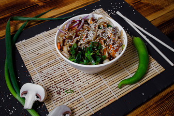 Asian food, wok noodles in the interior, wok in bowl