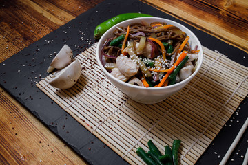 Asian food, wok noodles in the interior, wok in bowl