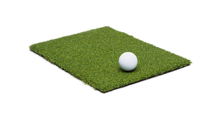 Golf Ball Resting on Section of Artificial Turf Grass On White Background
