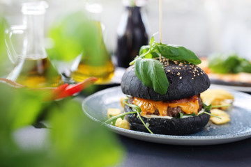 Cheeseburger in a black roll. Classic burger