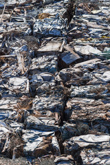 A garbage trash packs on a railway freight cars.