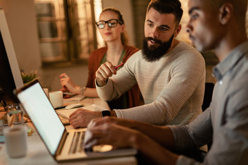 Young business people working on laptop in the office.