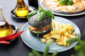 Cheeseburger in a black roll. Classic burger