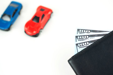 black wallet with money,cars on the background. cars for sale concept