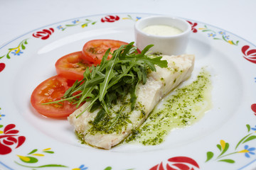 roasted fish with sauce and salad