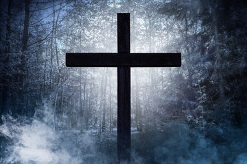 cross in scary forest