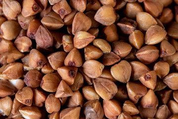 Texture background grain buckwheat groats. Macro photo.
