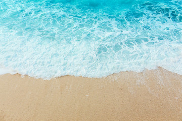 Fototapeta na wymiar Soft beautiful ocean wave on sandy beach. Background.