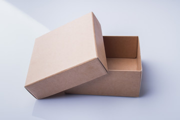 Uncovered small cardboard box. Two pieces of a corrugated container.