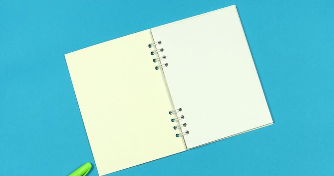 Animated stop motion. A notebook opens to him ballpoint pens crawl.