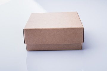 Closed two-piece cardboard box. Isilated on white, perspective view.