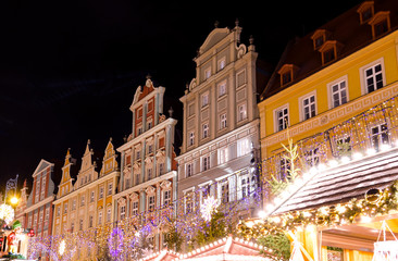 Fototapeta na wymiar Festive Market of Rynek Square Against Traditional Colorful Old Buildings.