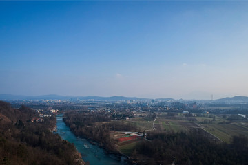Late afternoon panorama of slovenia capital Ljubljana, looking from the hill of Rasica on the north of Ljubljana. View of fields and forests on the outskirts of the city.