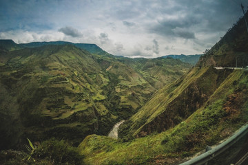 Lush and deep green valleys with heavy clouds above on the road between Ecuador and Colombia....