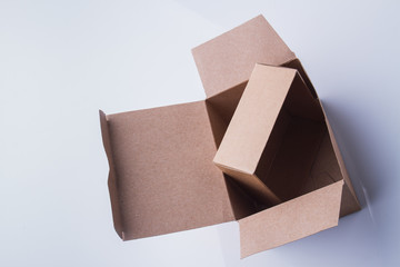 Small cardboard box inside a big one. Top view. Isolated on white.