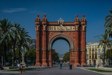 Fototapeta na wymiar Arc de triomphe or arch of triumph in Barcelona, Spain in a clear sunny day with only a few tourists lingering by. Frontal shot of Arc de Triomphe in Barcelona.