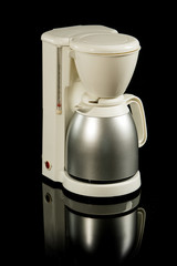 Plastic white filter coffee maker or machine with stainless steel mug isolated on black on...