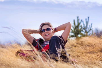 Woman with Backpack in the High Mountain 