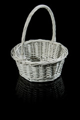 White wicker basket isolated on black.