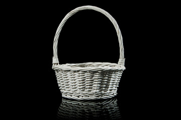 White wicker basket isolated on black.