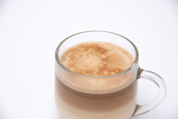 coffee with milk layers, cappuccino in a glass cup on a white background