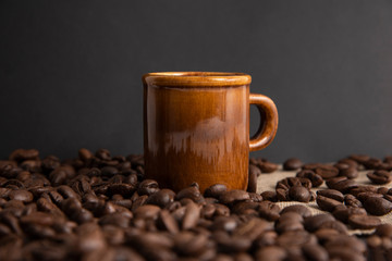 cup of coffee and beans on burlap with copy space for text.