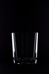 empty glass of whiskey on a black background