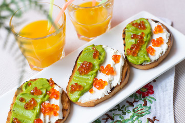 Toast with caviar and some orange juice