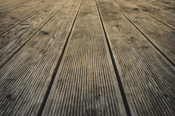 Detail of slats of a wooden terrace.  visible ridges on wooden boards used to make terrace floor.