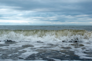 Oceanic waves during storm. Water roll forward and boils at shore, force of nature and beatyful powder blue ,aquamarine