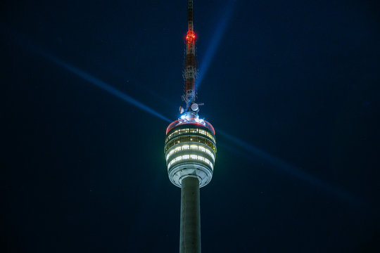 Stuttgart Television Tower (Fernsehturm) against night sky with stars and light beams, Germany