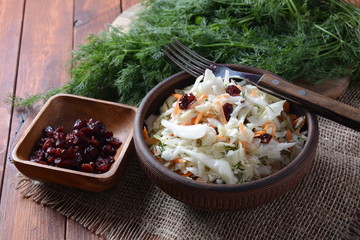 Cabbage salad with carrot, smoked almonds and dried cranberries. Coleslaw Salad.Fermented cabbage- Russian cuisine. Healthy vegan food concept.