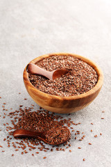 Uncooked linseed in wooden spoon, rustic style. Healthy linseed