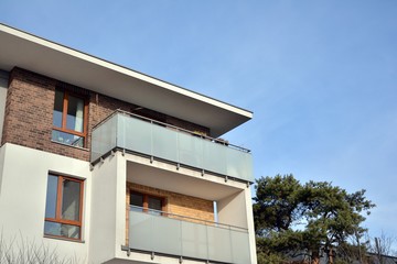 Modern apartment buildings on a sunny day with a blue sky. Facade of a modern apartment building.Glass surface with sunlight.