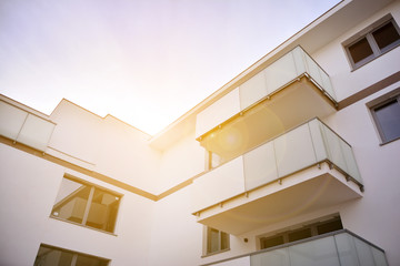 Modern apartment buildings on a sunny day with a blue sky. Facade of a modern apartment building.Glass surface with sunlight.