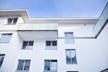 Modern apartment buildings on a sunny day with a blue sky. Facade of a modern apartment building.Glass surface with sunlight.