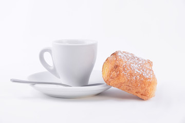 Cup of coffee with a half eaten bun