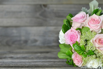 Bouquet of flowers on wooden background with copy space