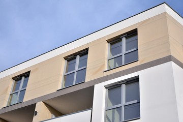 Modern apartment buildings on a sunny day with a blue sky. Facade of a modern apartment building.Glass surface with sunlight.
