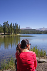 Fototapeta na wymiar Woman In Red Shirt By Dog Lake