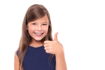 Little girl showing thumbs up on a white background.