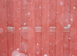 Red fence and snow falling background