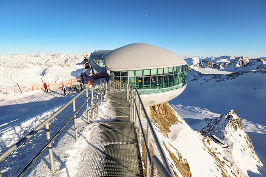 View from Pitztal glacier into the high alpine mountain landscape with cable car station and ski slope in winter with lots of snow and ice, Austrian Alps in Tirol Austria - Powered by Adobe