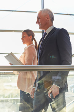 Smiling businessman on escalator in airport