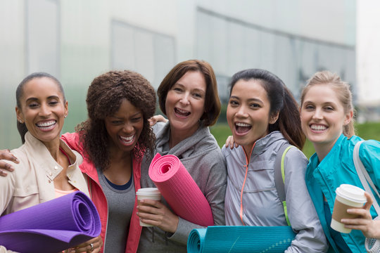 Portrait happy women friends with yoga mats and coffee