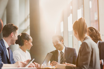 Smiling businessman leading conference room meeting
