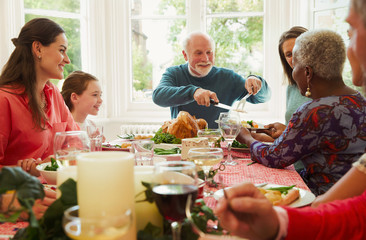 Multi-ethnic family enjoying Christmas dinner table
