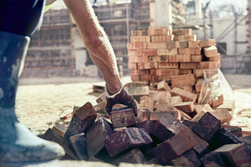 Construction worker bricklaying at construction site